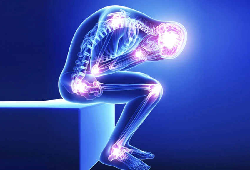 Illustration of a human figure in a fetal position, showcasing a glowing skeletal and muscular system against a blue background, symbolizing pain and discomfort.